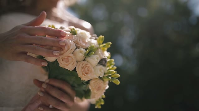 Bride Stroking Bridal Bouquet.