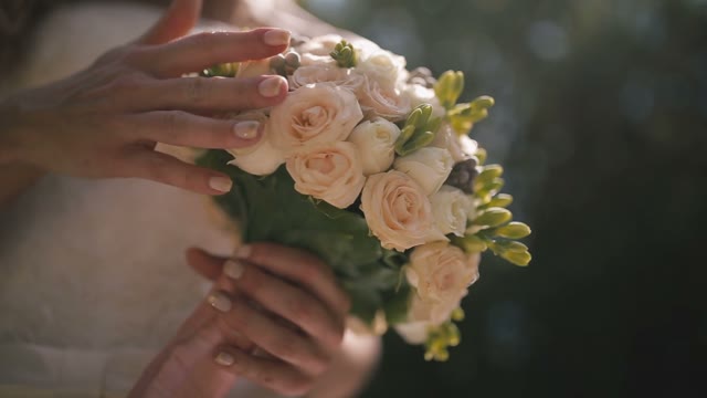 Bride Gently Stroking The Bridal Bouquet.