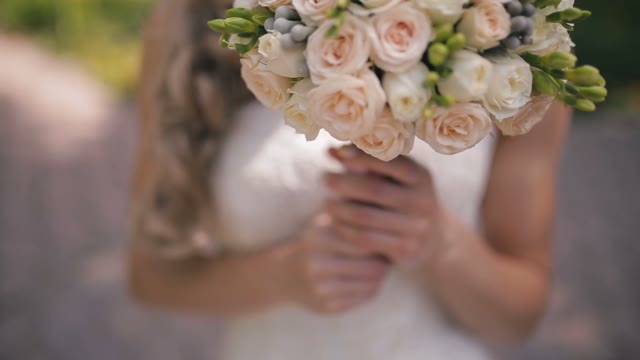 The Bride Holds A Wedding Bouquet.