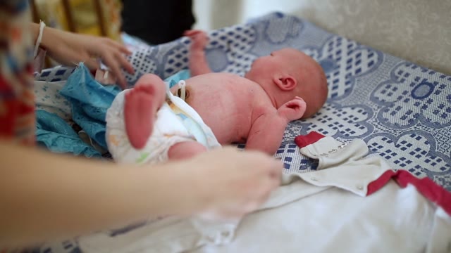 Swaddled Infant On A Couch. Close-up.
