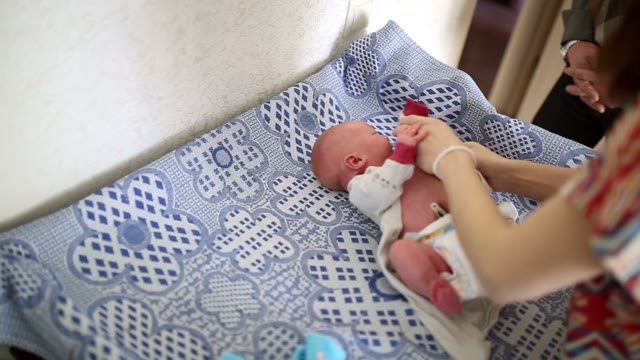 Mom Puts The Newborn.