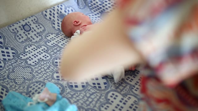 Mom Puts On Newborn Panties. Close-up.