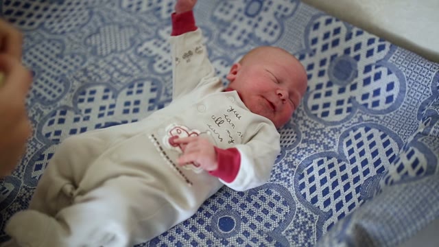 Newborn Wearing Mittens. Close-up.
