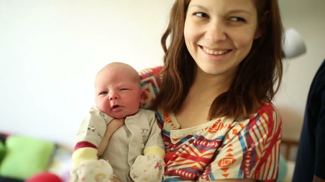 Mom Is Holding A Newborn. Close-up.