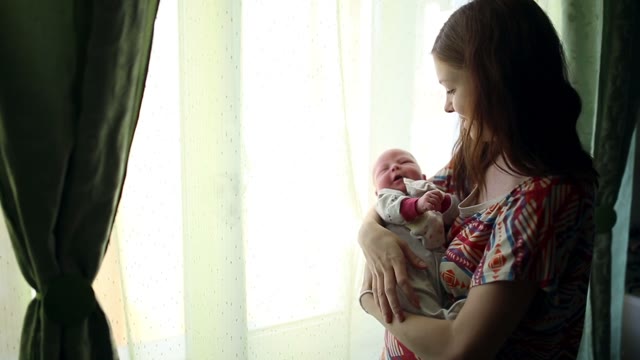 Mom Is Holding A Newborn, He Yawns.