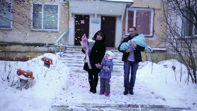 Happy Family With Children Goes On Camera. Around Confetti.