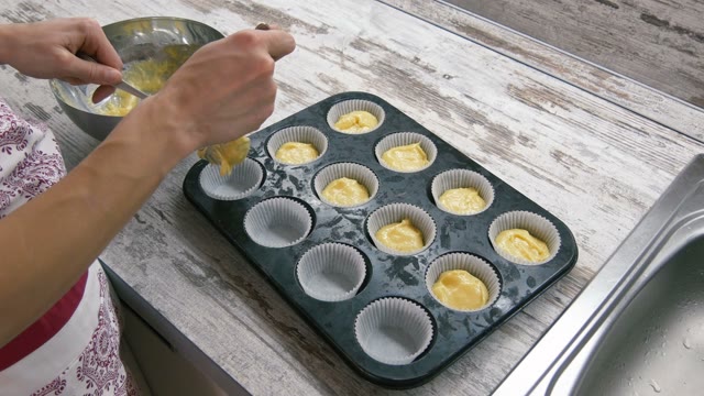 Preparation Of Cake. With Spoons Laid Out The Dough On The Cake Pan. Close-up.