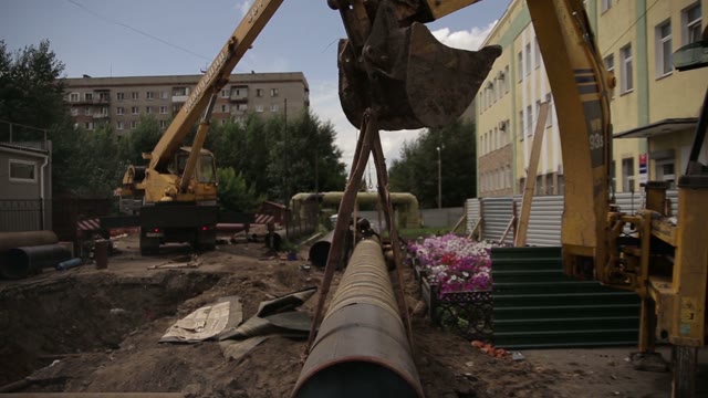 Construction Works. Excavator. Pipes. Welder.