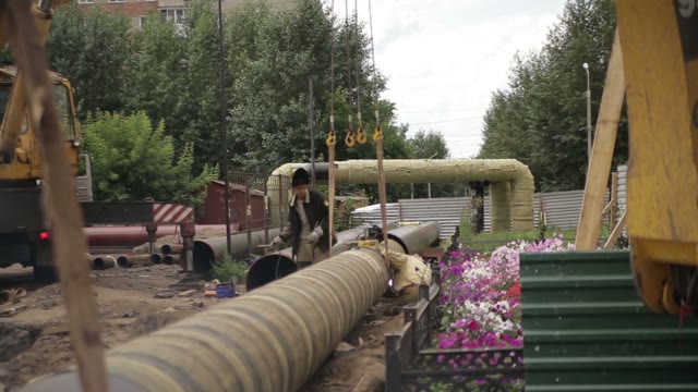 Repair Pipes. Two Workers Engaged In Welding.
