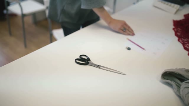 The Girl Draws Pencil On Paper. Close-up.