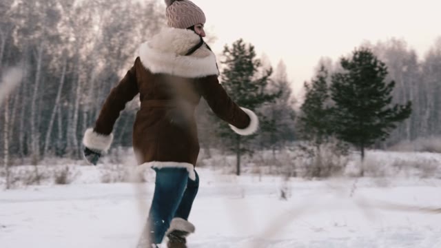 Young Girl Playing With A Dog In A Winter Field. Slow Motin
