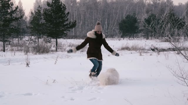 Girl Jumping And Running With A Dog In Winter Park. Slow Motin