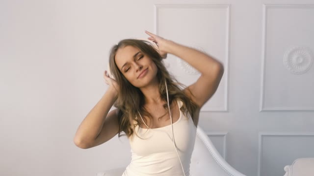 Young Girl Listening Music On Headphones And Dancing