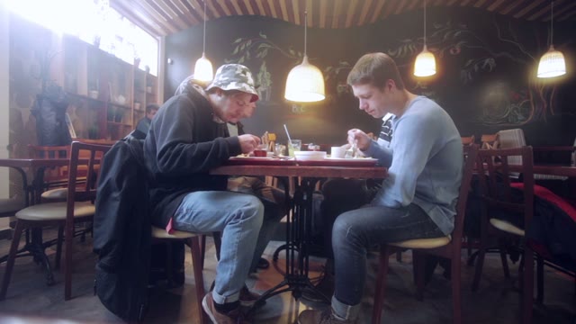 Four Young People Eating In Cafe. Time Lapse
