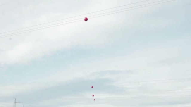 Red Balls On Wires. The View From The Car