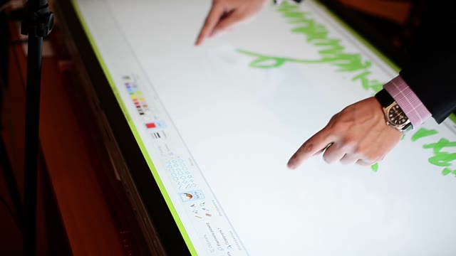 The Young Man Draws On A Large Touchscreen Computer. Close-up