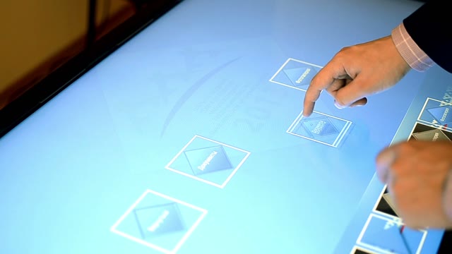 A Man Working On A Large Touchscreen Computer. Close-up