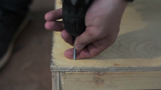 Man Uses Screwdriver. Close-up