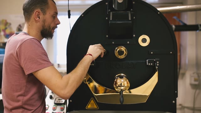 Young Man Working With A Coffee Machine
