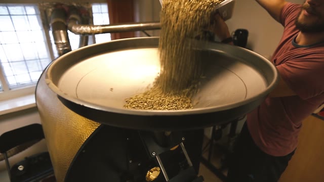 Green Coffee Beans Poured Into The Coffee Machines
