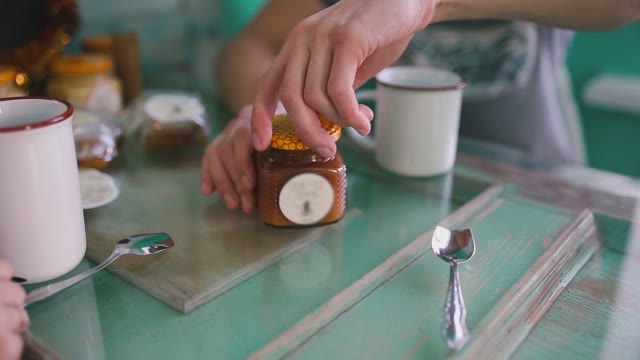 The Man Is Going To Drink Tea With Honey. Close-up