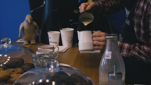 The Bartender At The Bar Pours Milk. Close-up. Slow Motion
