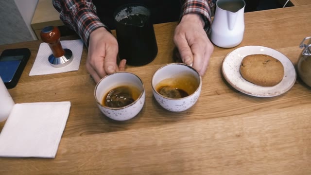 The Bartender Turns Coffee Cups And Milk. Slow Motion. Close-up