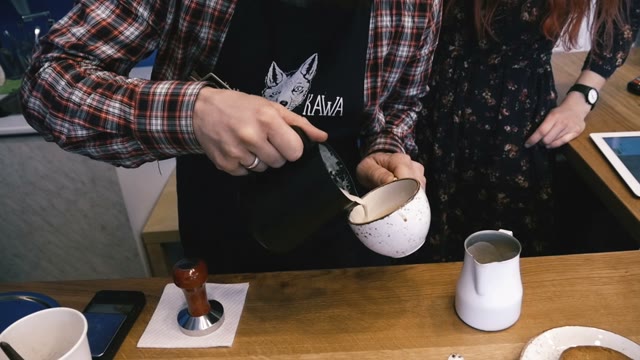 Barista Adds The Milk In Coffee. Slow Motion. Close-up