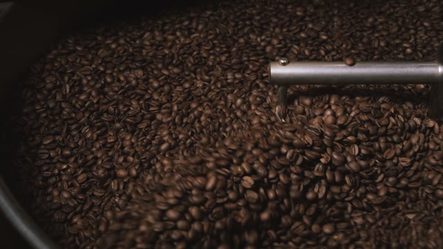 Coffee Machine Mixes Coffee Beans. Slow Motion. Close-up