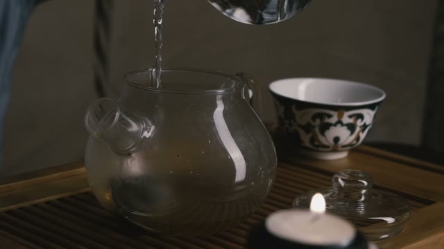 Chinese Tea Ceremony. Pour Boiling Water Into The Teapot. Close-up. Slow Motion