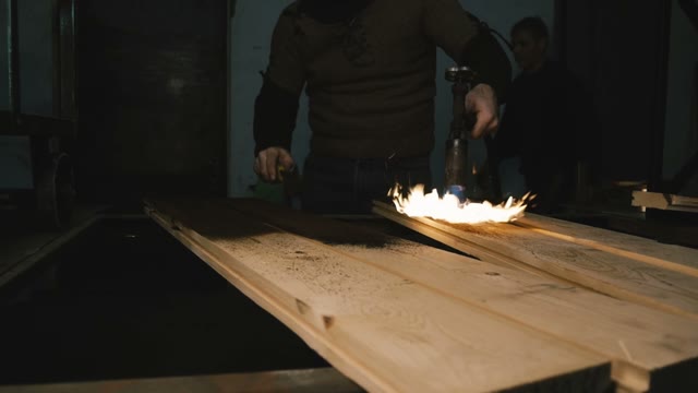 Joiner Burn Wood In The Woodworking Workshop. Close-up