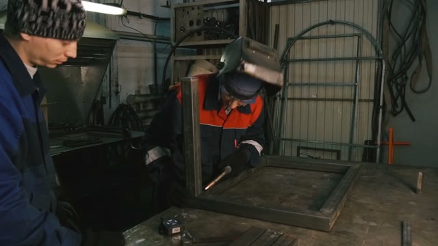 Man Works With The Welding Machine. Close-up