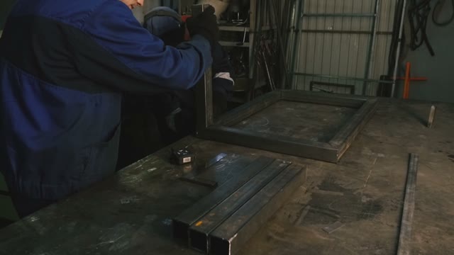 Two Men Are Working With Welding Apparatus. Close-up
