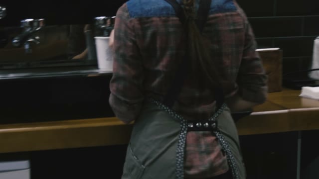 Beautiful Girl Behind The Bar Pours Coffee