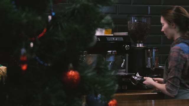 Barista Prepares Coffee. Near Christmas Tree