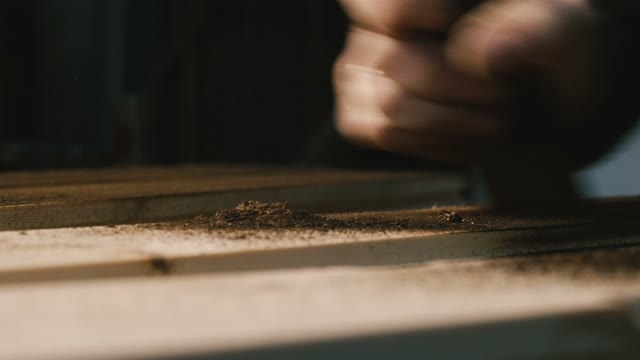 Carpenter Handles Burned Wood. Close-up