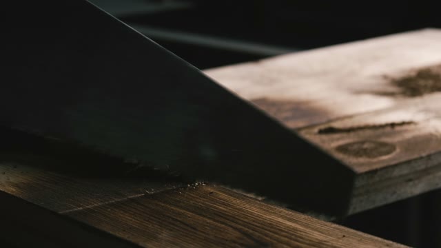Man Sawing Wood. Close-up