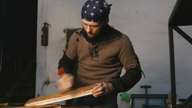 Carpenter Shakes Off Dust With A Brush