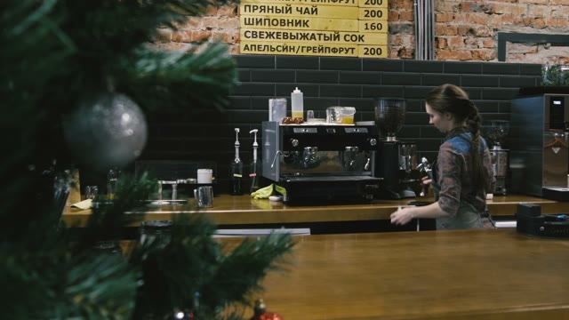 Woman Makes Coffee At The Bar Counter