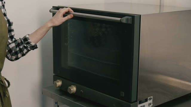 Woman Cooks Food In An Oven