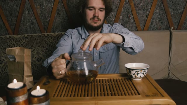 The Young Man At The Tea Table. Close-up