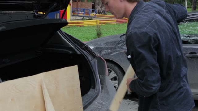 Man Puts From The Car Bars And Tools