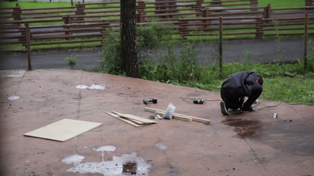 Man Getting Ready To Work With A Drill