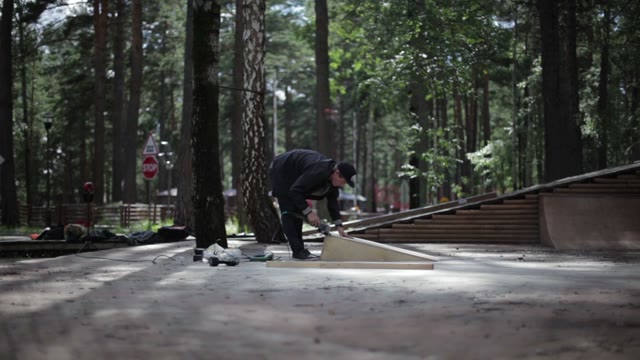 Man Polishing A Goods From Wood In The Skatepark