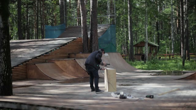 Man Working Grinder Machine In The Skatepark