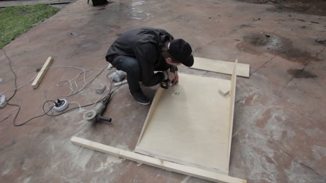 Man Drills Wood Products In Skatepark