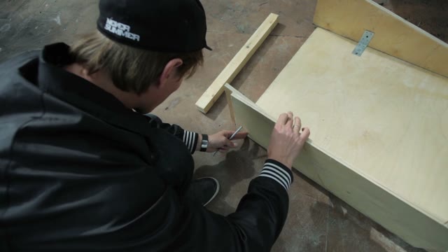 Man Makes Marks On Items Made Of Wood In The Skatepark