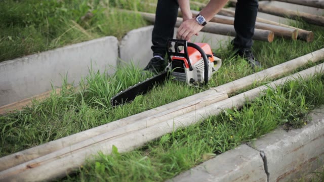 Man Sawing A Log Chainsaw