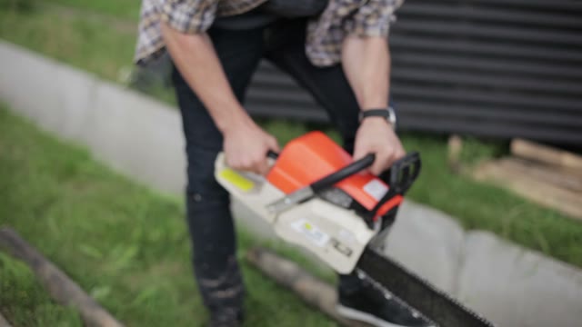 Man Saws Off A Piece Of Timber