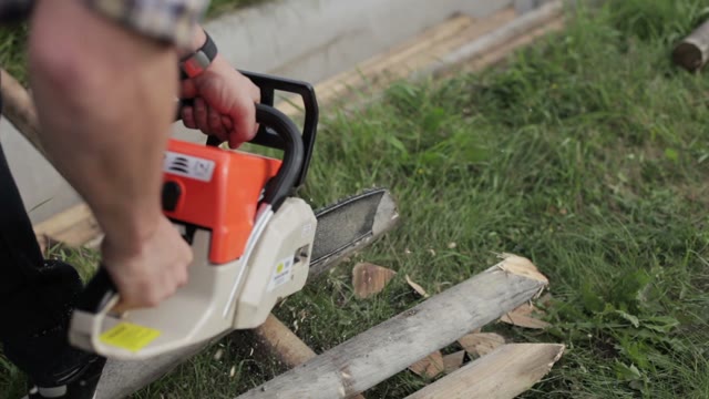 Man Works Chainsaw Close-up